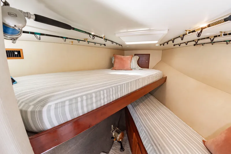 Slide: The Image of The image shows a cozy cabin with two beds, fishing rod holders, and pillows. - 45