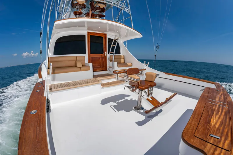 Slide: The Image of The image shows the stern of a 2004 Custom Carolina 61' Sportfisherman on the ocean. - 7