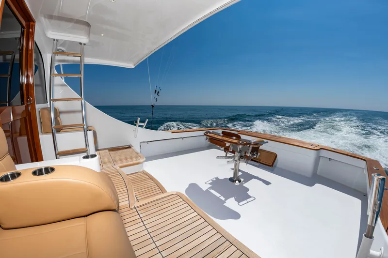 Slide: The Image of The image shows the deck of a 2004 Custom Carolina 61' Sportfisherman on open water. - 6