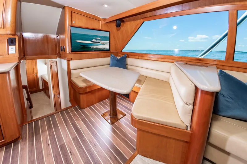 Slide: The Image of Interior of a 2004 Custom Carolina 61' Sportfisherman with wood flooring and beige upholstery. - 26