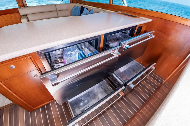 Slide: The Image of The galley of a 2004 Custom Carolina 61' Sportfisherman with stainless steel drawer refrigerators. - 30