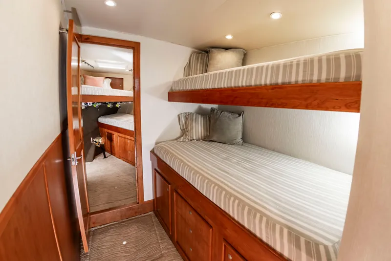 Slide: The Image of Interior of a 2004 Custom Carolina 61' Sportfisherman with bunk beds and wooden furnishings. - 37