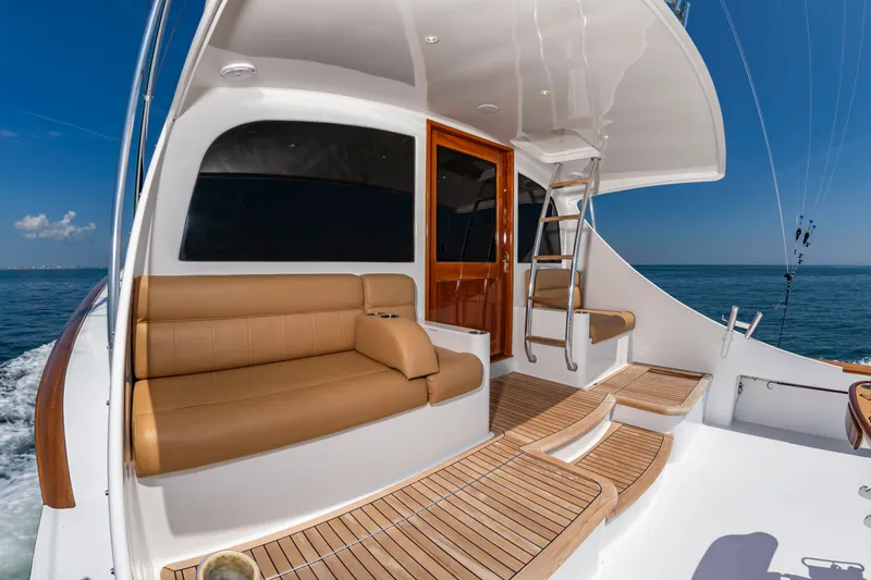 Slide: The Image of The image shows the deck of a 2004 Custom Carolina 61' Sportfisherman with brown seating. - 10