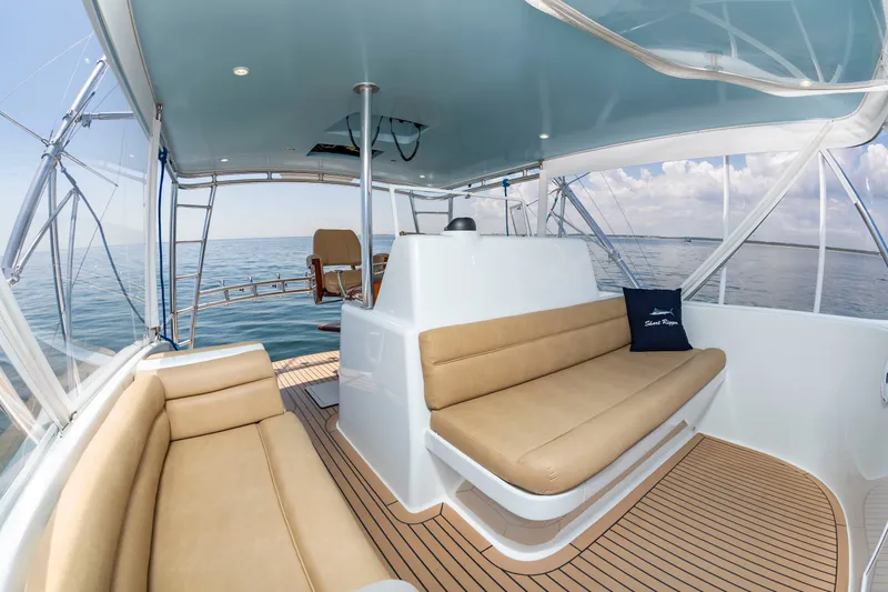 Slide: The Image of The image shows the deck of a 2004 Custom Carolina 61' Sportfisherman with beige seating. - 20