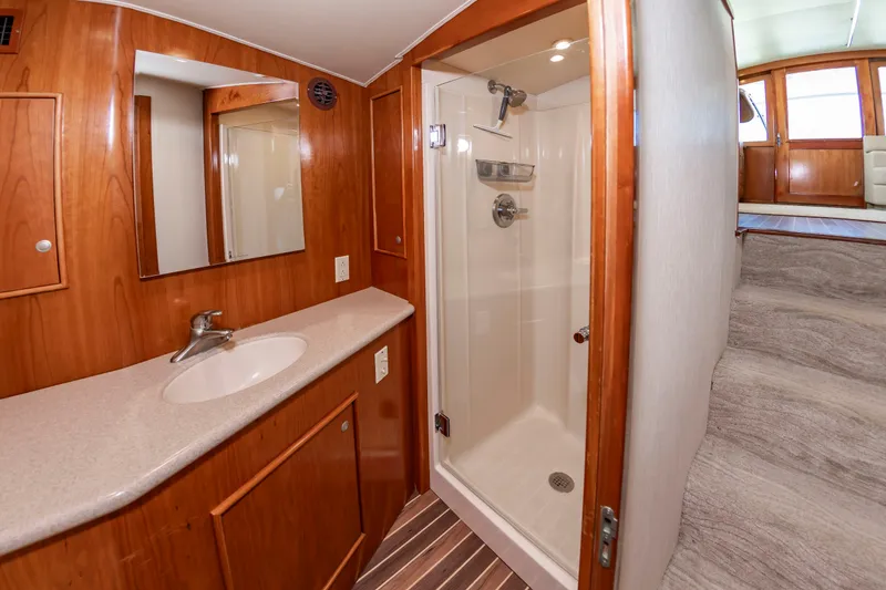 Slide: The Image of The image shows a bathroom with a shower, sink, and wood paneling. - 39