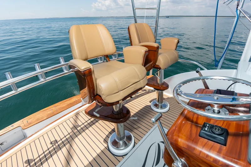 Slide: The Image of Two luxurious captain's chairs on a sportfisherman boat overlooking the open sea. - 17