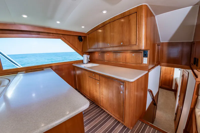 Slide: The Image of Interior of a 2004 Custom Carolina 61' Sportfisherman with wooden cabinetry and ocean view. - 28
