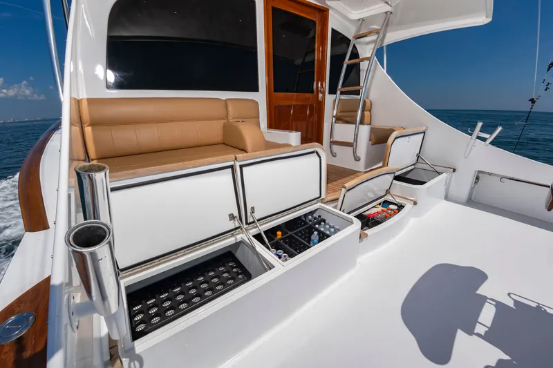 Slide: The Image of The image shows the deck of a 2004 Custom Carolina 61' Sportfisherman with seating and storage. - 12