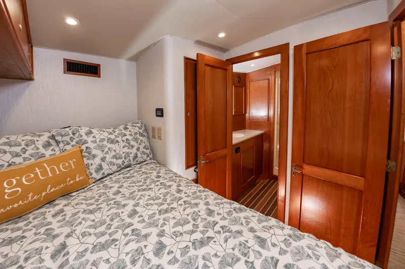 Slide: The Image of Bedroom with a double bed, wooden doors, and a decorative pillow. - 33