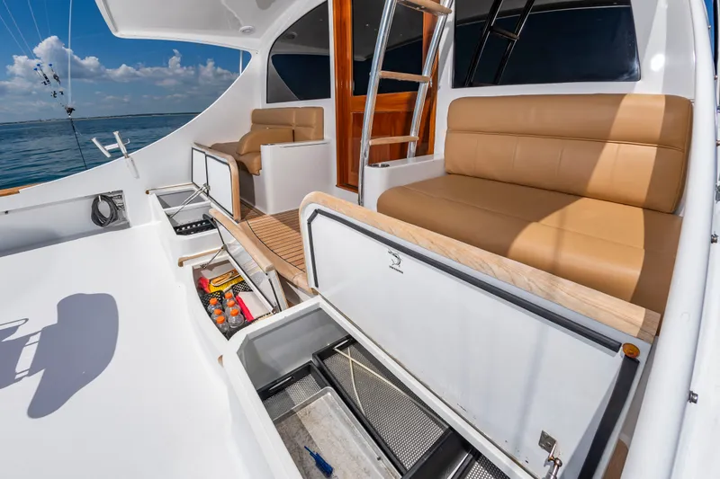 Slide: The Image of The image shows the deck of a 2004 Custom Carolina 61' Sportfisherman with beige seating. - 13
