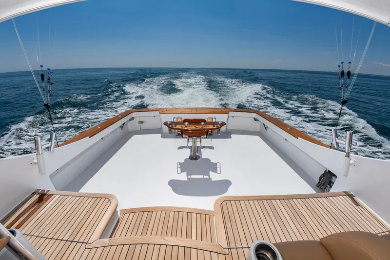 Slide: The Image of The image shows the stern of a 2004 Custom Carolina 61' Sportfisherman on open water. - 5