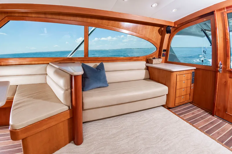Slide: The Image of Interior of a luxury yacht with leather sofa, wooden furnishings, and large windows overlooking the sea. - 24