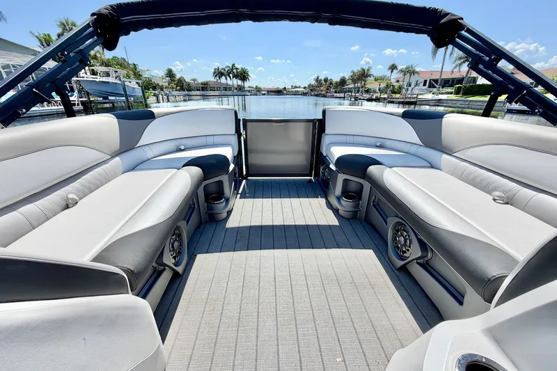 Slide: The Image of 2023 Avalon 2385 LSZ pontoon boat interior with spacious seating and waterfront view. - 17