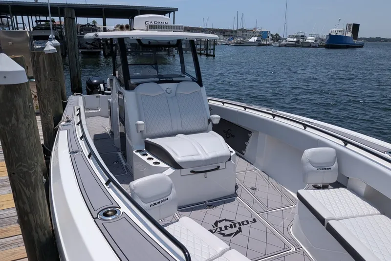Slide: The Image of 2023 Fountain Bluewater 38 Tournament Edition boat docked at marina, showcasing sleek design. - 22