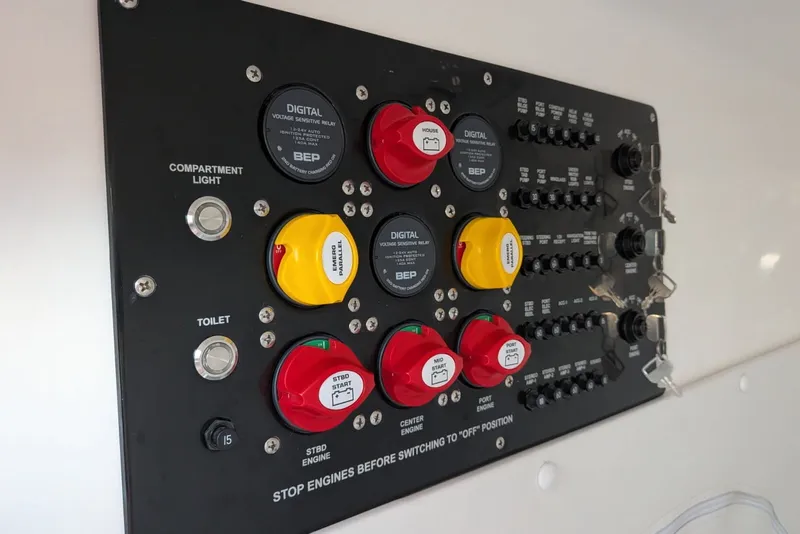 Slide: The Image of Control panel of 2023 Fountain Bluewater 38 Tournament Edition boat with switches and indicators. - 16