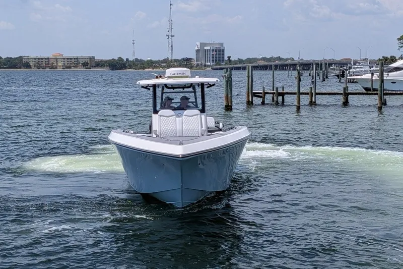 Slide: The Image of 2023 Fountain Bluewater 38 Tournament Edition boat on water near docks. - 5