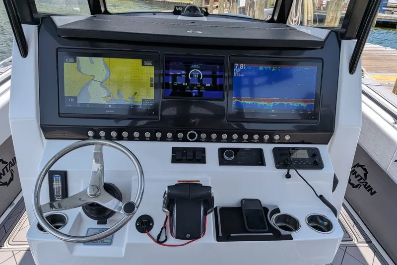 Slide: The Image of Dashboard of 2023 Fountain Bluewater 38 Tournament Edition with navigation screens and controls. - 17