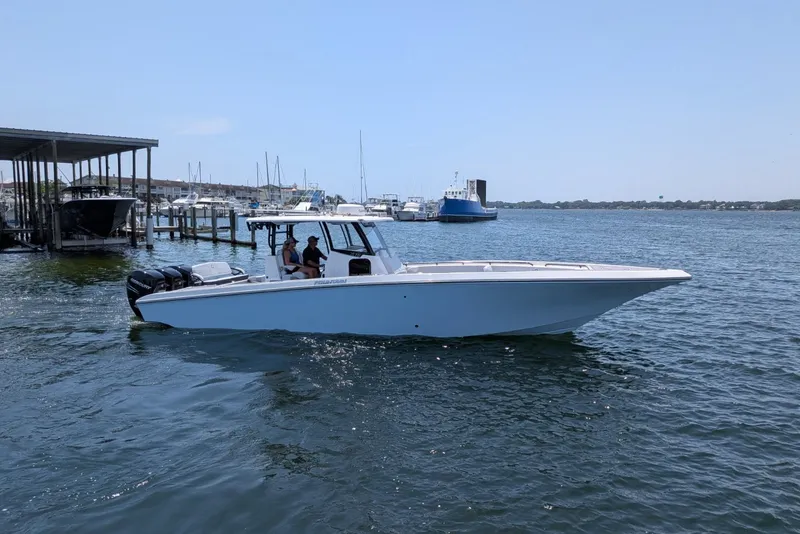 The Image of 2023 Fountain Bluewater 38 Tournament Edition boat cruising in a marina. - 1