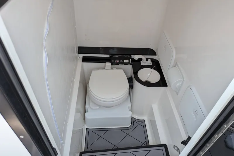 Slide: The Image of 2023 Fountain Bluewater 38 Tournament Edition boat bathroom interior with toilet and sink. - 15