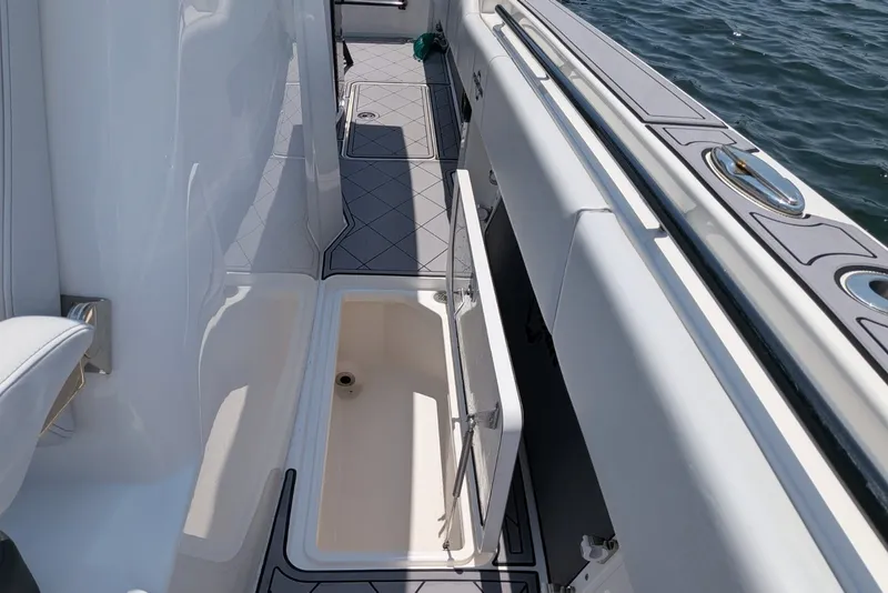 Slide: The Image of 2023 Fountain Bluewater 38 Tournament Edition boat interior with open storage compartment. - 13