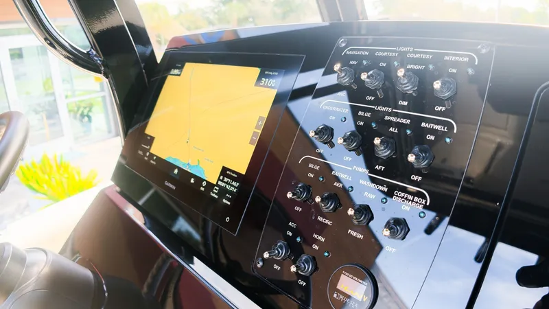 Slide: The Image of The image shows the dashboard of a Scout 240 XSF boat with a navigation screen and various switches. - 22