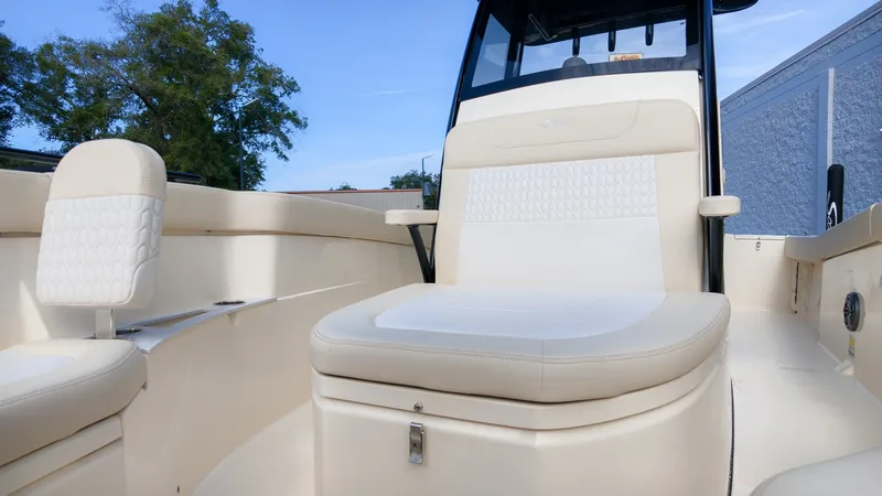 Slide: The Image of The image shows the cockpit of a Scout 240 XSF boat with beige upholstery and a helm station. - 19