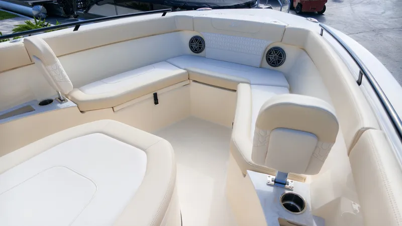 Slide: The Image of The image shows the interior of a Scout 240 XSF boat with beige upholstery and speakers. - 15
