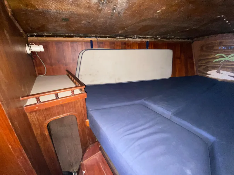 Slide: The Image of 1978 Sailboat MSY 38 interior cabin with blue cushions and wooden paneling. - 28
