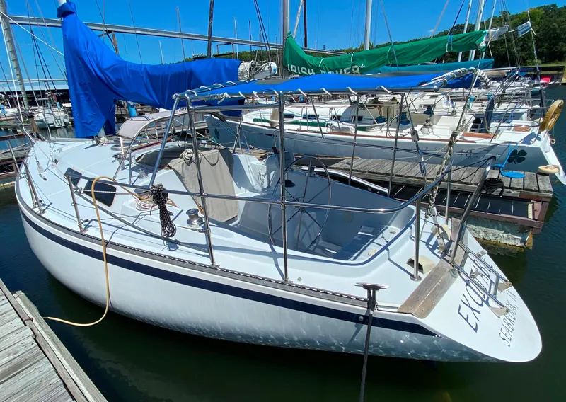 Slide: The Image of 1978 Sailboat MSY 38 docked, covered with blue tarp, surrounded by other boats. - 3
