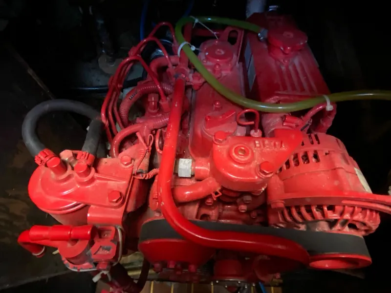 Slide: The Image of Red engine of a 1978 Sailboat MSY 38 with visible hoses and components. - 33
