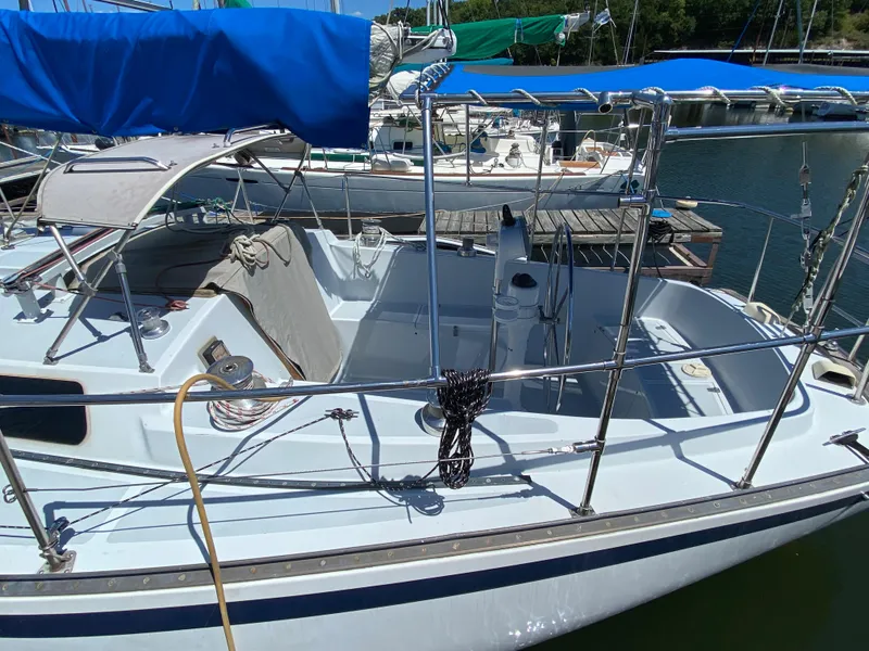 Slide: The Image of 1978 Sailboat MSY 38 docked, featuring a clean deck and blue canopy. - 4