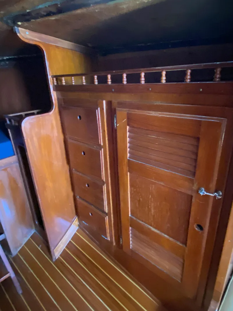 Slide: The Image of 1978 Sailboat MSY 38 interior with wooden cabinets and drawers. - 25