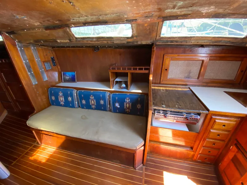 Slide: The Image of 1978 Sailboat MSY 38 interior with wooden cabinetry and cushioned seating. - 17