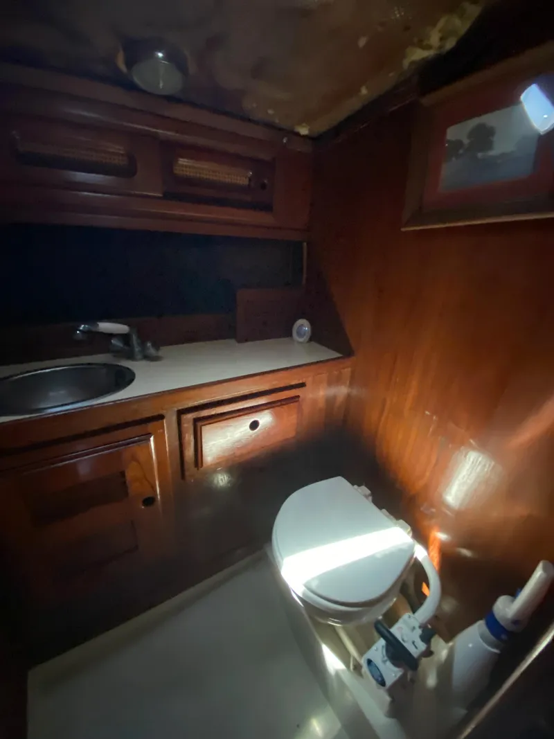 Slide: The Image of 1978 Sailboat MSY 38 bathroom with wooden cabinetry and sink. - 31