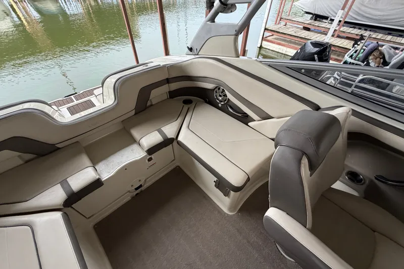 Slide: The Image of Interior of a 2015 Yamaha Boats 242 Limited S, featuring beige seating and sleek design. - 12