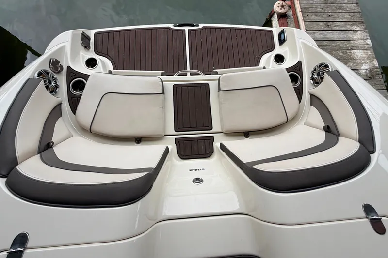 Slide: The Image of 2015 Yamaha Boats 242 Limited S, featuring luxurious seating and sleek design at the dock. - 10