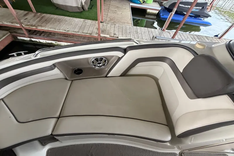 Slide: The Image of The image shows the bow seating area of a 2015 Yamaha 242 Limited S boat with cushioned seats. - 24
