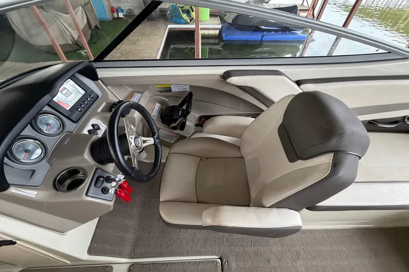 Slide: The Image of 2015 Yamaha Boats 242 Limited S cockpit with steering wheel and dashboard controls. - 18
