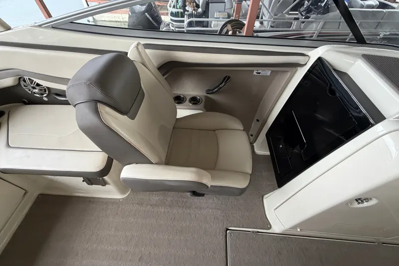 Slide: The Image of Interior of a 2015 Yamaha Boats 242 Limited S, featuring a beige and gray seat. - 14