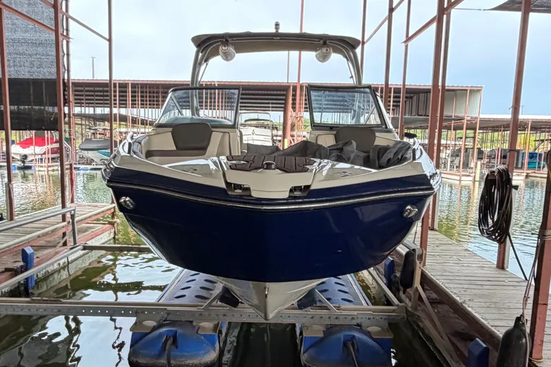 Slide: The Image of 2015 Yamaha Boats 242 Limited S in marina, front view, docked on lift. - 4