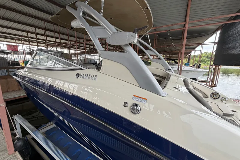 Slide: The Image of 2015 Yamaha Boats 242 Limited S in marina, showcasing sleek design and luxury features. - 6