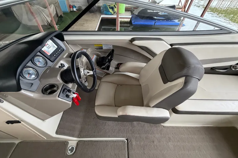 Slide: The Image of Interior of 2015 Yamaha Boats 242 Limited S, featuring steering wheel and dashboard controls. - 17
