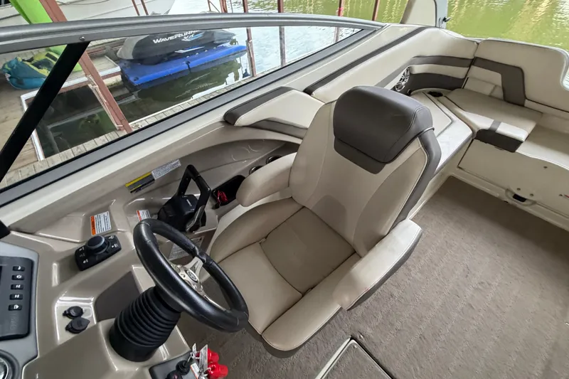 Slide: The Image of 2015 Yamaha Boats 242 Limited S interior with steering wheel and seating area. - 19