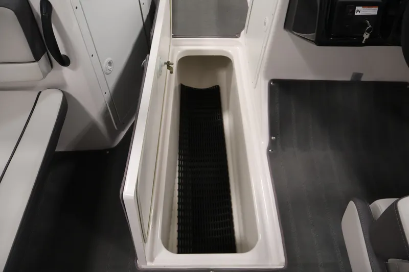 Slide: The Image of 2021 Yamaha AR190 boat interior storage compartment with open hatch and seating area. - 31