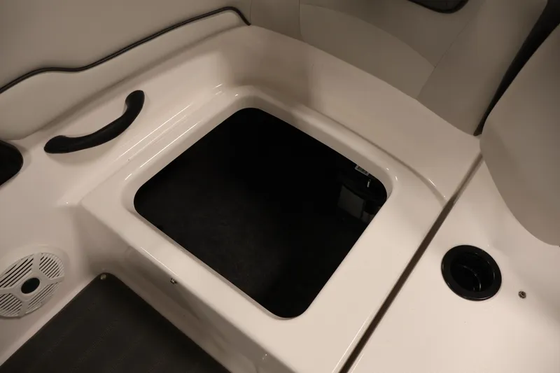 Slide: The Image of 2021 Yamaha AR190 boat interior storage compartment with speaker and cup holder. - 36