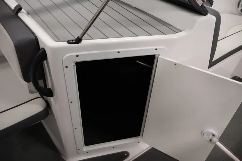 Slide: The Image of Open storage compartment on a 2021 Yamaha Boats AR190. - 29