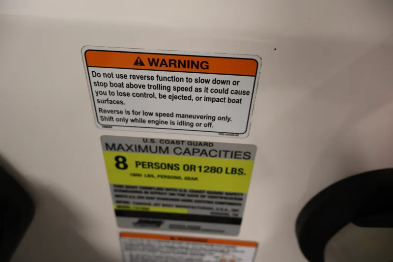 Slide: The Image of Warning label on 2021 Yamaha Boats AR190, indicating maximum capacity and reverse function caution. - 25