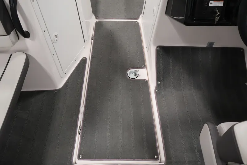 Slide: The Image of Interior view of 2021 Yamaha AR190 boat, featuring sleek gray flooring and seating. - 30