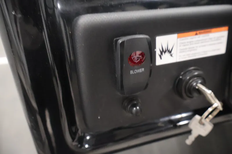Slide: The Image of Control panel of a 2021 Yamaha AR190 boat with blower switch and ignition keys. - 23