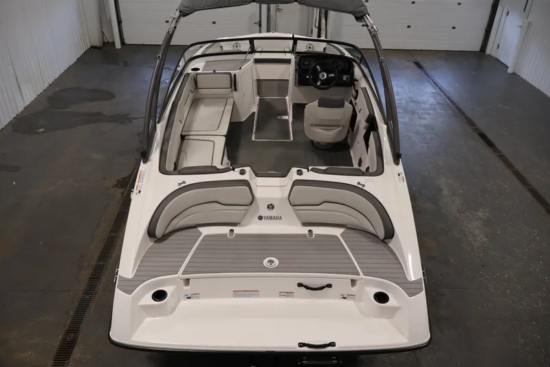 Slide: The Image of 2021 Yamaha Boats AR190 interior view, showcasing seating and helm in a spacious layout. - 9